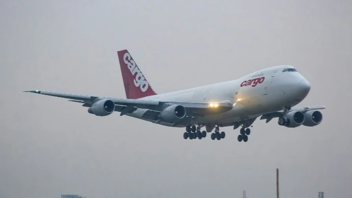 A large jetliner flying through a foggy sky